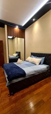 a bedroom with a large bed with a large mirror at Lux apartment in city center in Belgrade