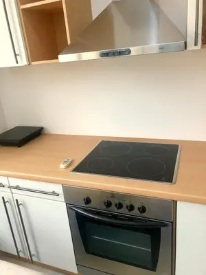 a kitchen with a stove top oven in a kitchen at Apartment Duplex in Pančevo