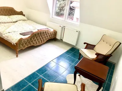 a bedroom with a bed and a desk and a chair at Apartment Duplex in Pančevo
