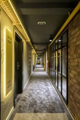 an empty corridor of a building with a brick wall at 7 Rooms Suites in Belgrade