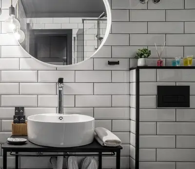 a white bathroom with a sink and a mirror at 7 Rooms Suites in Belgrade