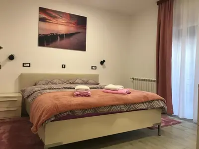 a bedroom with a bed with two towels on it at MM Apartmani in Belgrade