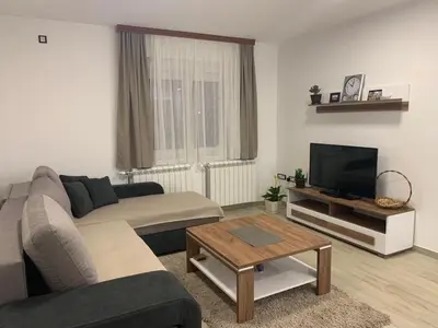 a living room with a couch and a tv at MM Apartmani in Belgrade