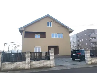 a house with a car parked in front of it at MM Apartmani in Belgrade