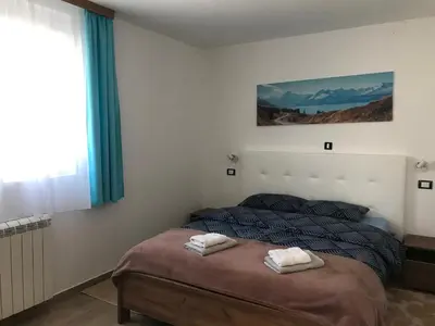 a bedroom with a bed with two towels on it at MM Apartmani in Belgrade