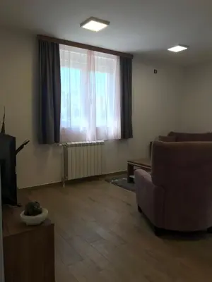 a living room with a couch and a television at MM Apartmani in Belgrade