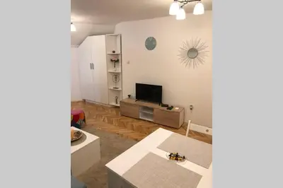 a living room with a television and a table at Apartman Iva in Belgrade