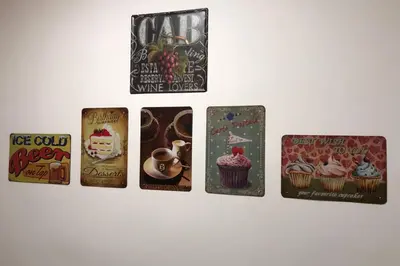 a row of cards with cupcakes on a wall at Apartman Iva in Belgrade