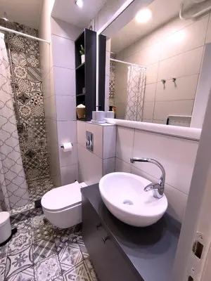 a bathroom with a sink and a toilet and a mirror at Sava river in Belgrade