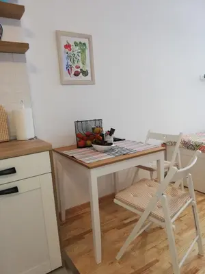 a small kitchen with a white table and a chair at Sava river in Belgrade