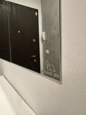 a mirror on the wall of a bathroom at Studio IKA Belgrade Airport Free Parking possible Self Check-In Terrace in Ledine