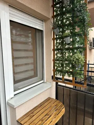 a window with a wooden bench next to a window at Studio IKA Belgrade Airport Free Parking possible Self Check-In Terrace in Ledine