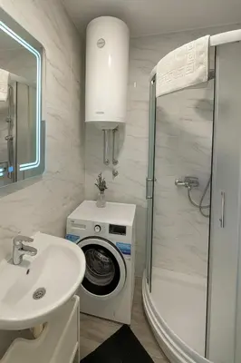 a bathroom with a washing machine and a sink at Studio IKA Belgrade Airport Free Parking possible Self Check-In Terrace in Ledine