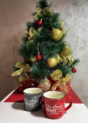 a christmas tree with two coffee cups in front of a christmas tree at Studio IKA Belgrade Airport Free Parking possible Self Check-In Terrace in Ledine
