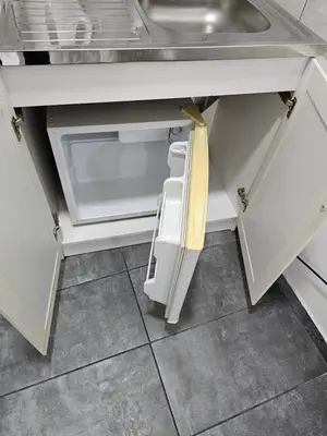 an open drawer in a kitchen with a sink at Apartman Viktor in Belgrade