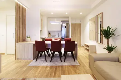 a kitchen and living room with a table and chairs at MVP apartment - Belgrade Waterfront in Belgrade
