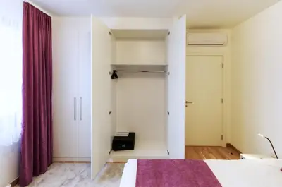 a bedroom with a bed and a closet at MVP apartment - Belgrade Waterfront in Belgrade