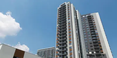 a tall apartment building against a blue sky at MVP apartment - Belgrade Waterfront in Belgrade