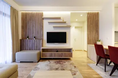 a living room with a television and a staircase at MVP apartment - Belgrade Waterfront in Belgrade