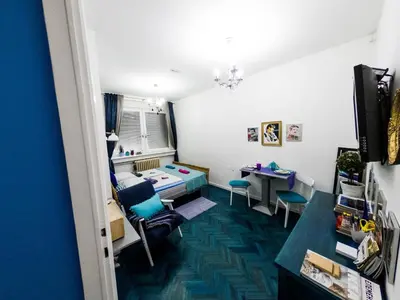 a room with a desk and a table and chairs at Apartment Tesla Wizard in Belgrade