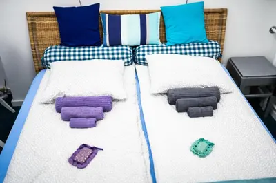a bed with two pillows and a bedframe with at Apartment Tesla Wizard in Belgrade