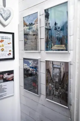 a group of pictures hanging on a wall at Apartment Tesla Wizard in Belgrade