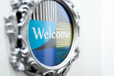 a mirror with a welcome sign on it at Apartment Tesla Wizard in Belgrade