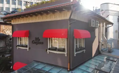 a building with red awnings on the side of it at Eclat Luxury Hotel in Belgrade