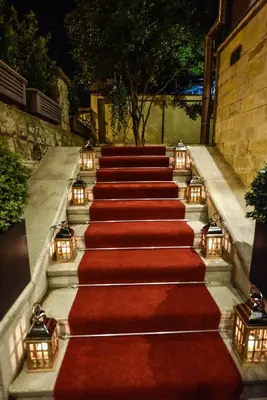 a set of stairs with red carpet and lights at Eclat Luxury Hotel in Belgrade