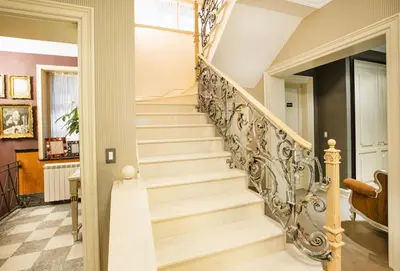 a staircase in a home with a white stair case at Eclat Luxury Hotel in Belgrade