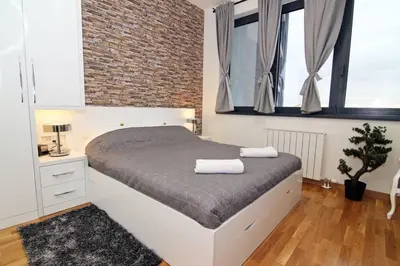a bedroom with a bed with two towels on it at Beograd Promenada Waterfront in Belgrade