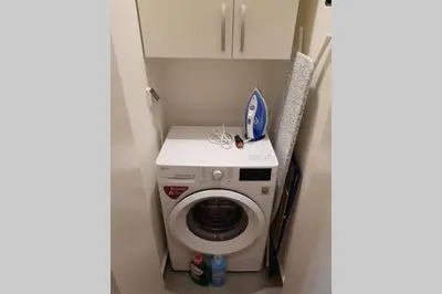 a washer and dryer in a small room at Beograd Promenada Waterfront in Belgrade
