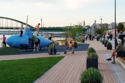 a group of people playing on a playground in a park at Beograd Promenada Waterfront in Belgrade