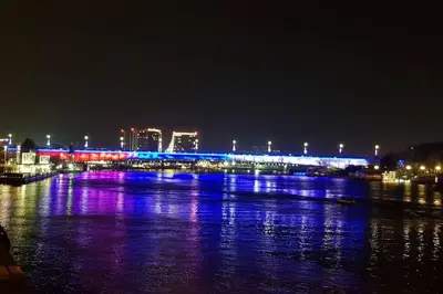 a bridge over a river at night with lights at Beograd Promenada Waterfront in Belgrade