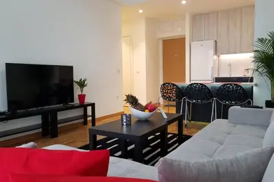 a living room with a couch and a tv and a table at Belgrade Waterfront Lux 1 in Belgrade