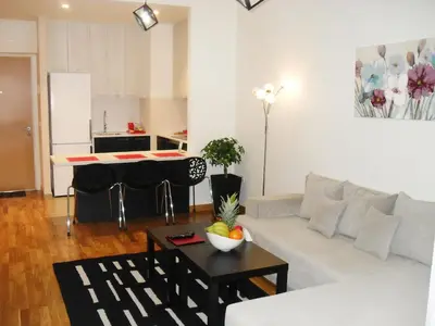 a living room with a white couch and a table at Belgrade Waterfront Lux 1 in Belgrade
