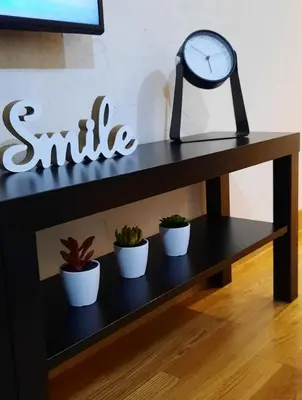 a shelf with three plants and a clock on it at Belgrade Waterfront Lux 1 in Belgrade