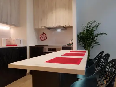 a kitchen with a table with a red rug on it at Belgrade Waterfront Lux 1 in Belgrade