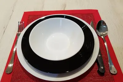 a black and white plate with a fork and knife at Belgrade Waterfront Lux 1 in Belgrade