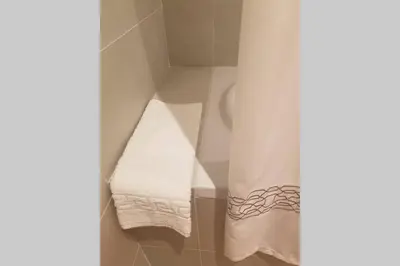 a bathroom with a shower curtain and a towel at Belgrade Waterfront Lux 1 in Belgrade