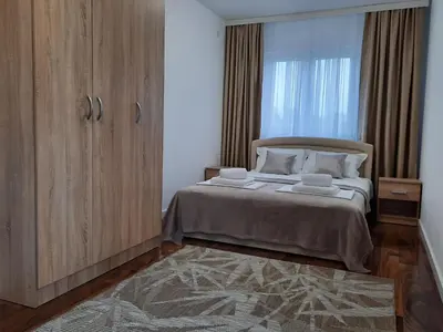 a bedroom with a bed and a large window at Divizija Lux apartments in Belgrade