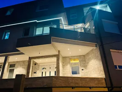 a building with a balcony on the side of it at MAGIC M Apartment in Mali Mokri Lug