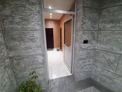 an empty hallway with a stone wall at MAGIC M Apartment in Mali Mokri Lug