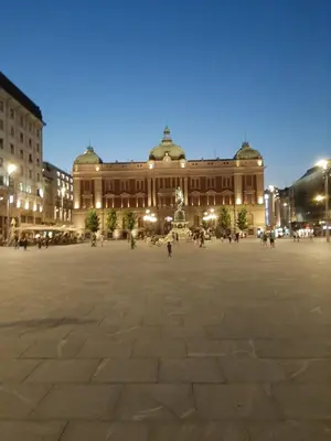 a large plaza in front of a building at night at Apartments best city place in Belgrade