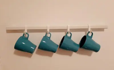 a group of four blue pots hanging on a shelf at Apartments best city place in Belgrade