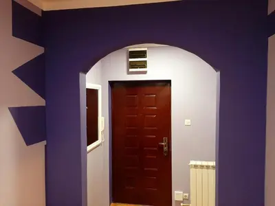 a room with a blue wall and a door at Apartments best city place in Belgrade
