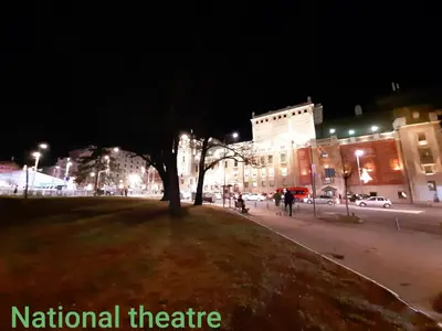 a park with a tree in the middle of a city at night at Apartments best city place in Belgrade