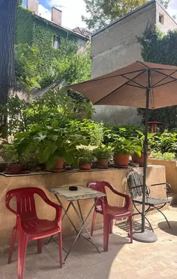 two chairs and a table with an umbrella on a patio at Mosaic in Belgrade
