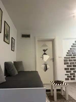 a white room with a bed and a table at Mosaic in Belgrade