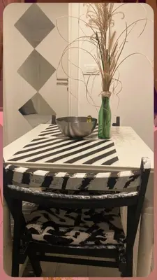 a black and white table with a vase on it at Mosaic in Belgrade